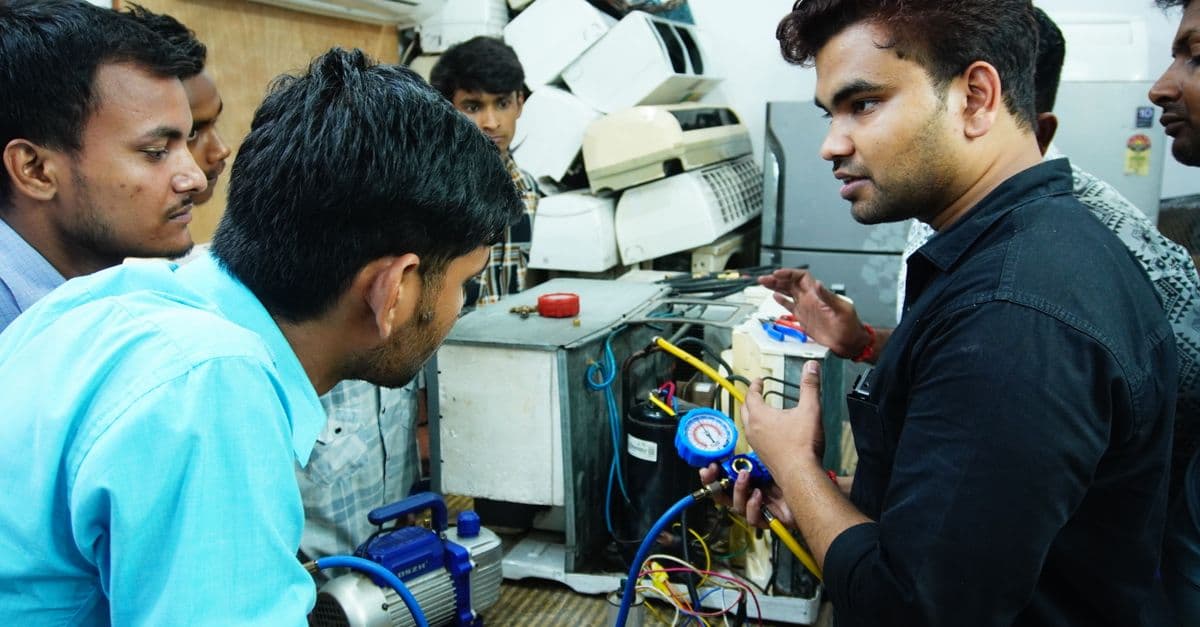 HVAC professional at work using GreenRoute field service software