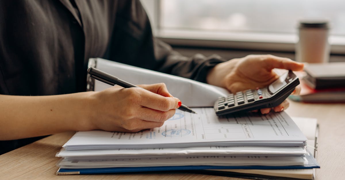 Calculator and business documents for lawn care service pricing