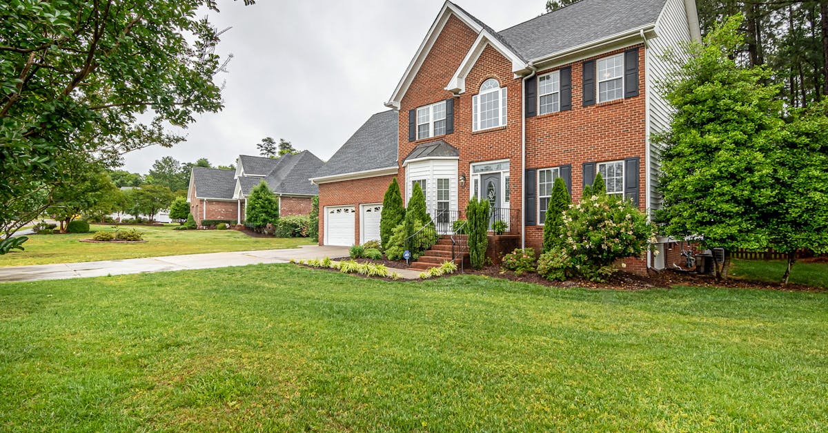 Charming house with a beautifully manicured lawn, showcasing professional lawn care results